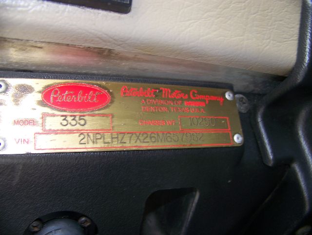 Peterbilt 335 model tag showing Peterbilt logo and serial plate with model 335 and VIN 2NPLHZ7X26M657982.