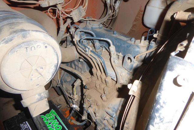 Laymor engine bay showing diesel engine block with turbo housing and fuel lines, wiring harness, and a green label partially visible near the bottom left.