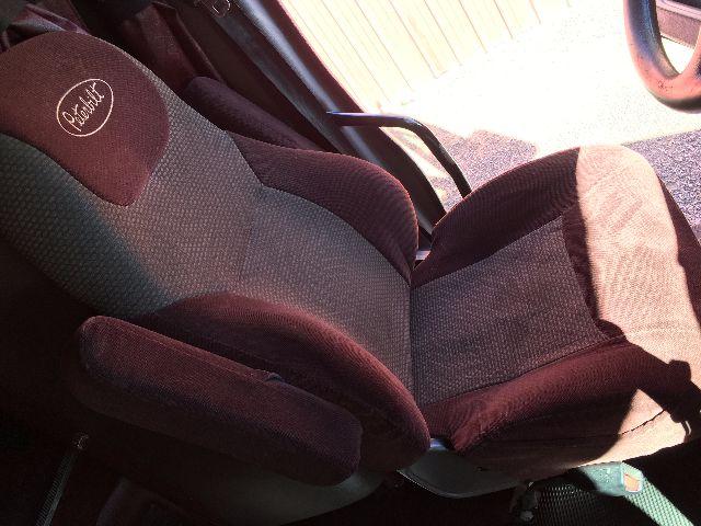 Peterbilt interior seat and steering wheel area. Text on headrest reads 'Peterbilt' in circular logo.