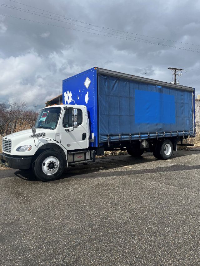 Box truck showing 2017 Freightliner M2 106 with white cab and blue cargo trailer.