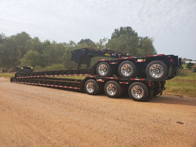 2020 Atoka RGN-553-S lowboy trailer with multiple axles and a folded gooseneck on a dirt lot.