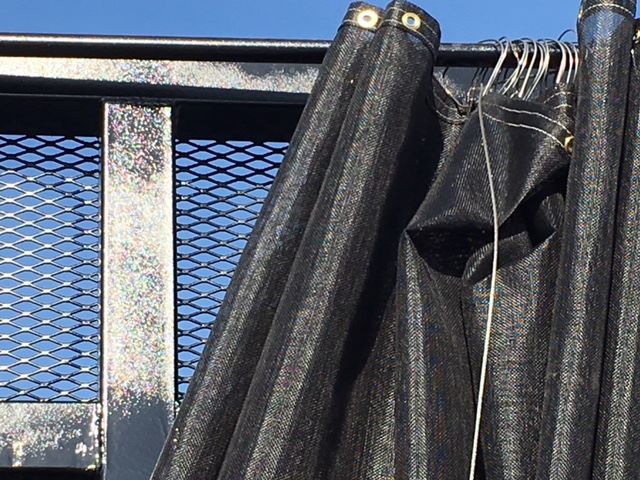 Trailer rear area with black curtain and metal mesh, part of a 2002 Great Dane single drop trailer for crushed car carrier.