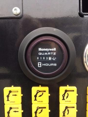 Knurled clock-like instrument labeled Homewelt GAA?72 with hours dial, surrounded by yellow switches in a black control panel.