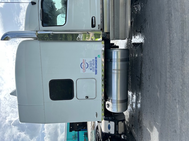 Peterbilt 579 tractor cab side and fuel tank with Century sticker visible.