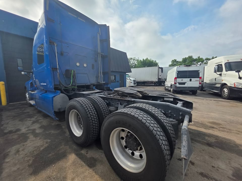 Side view of a blue 2018 International LT tractor with dual rear axles and ISX engine area visible.