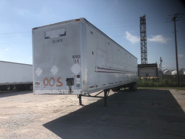 Trailer side and rear view of a used 2000 Wabash 53X102 cargo trailer with support legs down, markings and caution stickers visible.