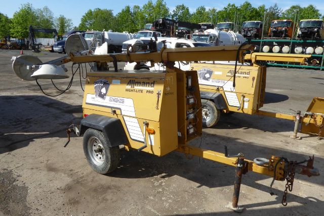 Allmand Night-Lite Pro portable light tower with trailer and extendable mast, yellow/cream color, tires, and hitch visible.