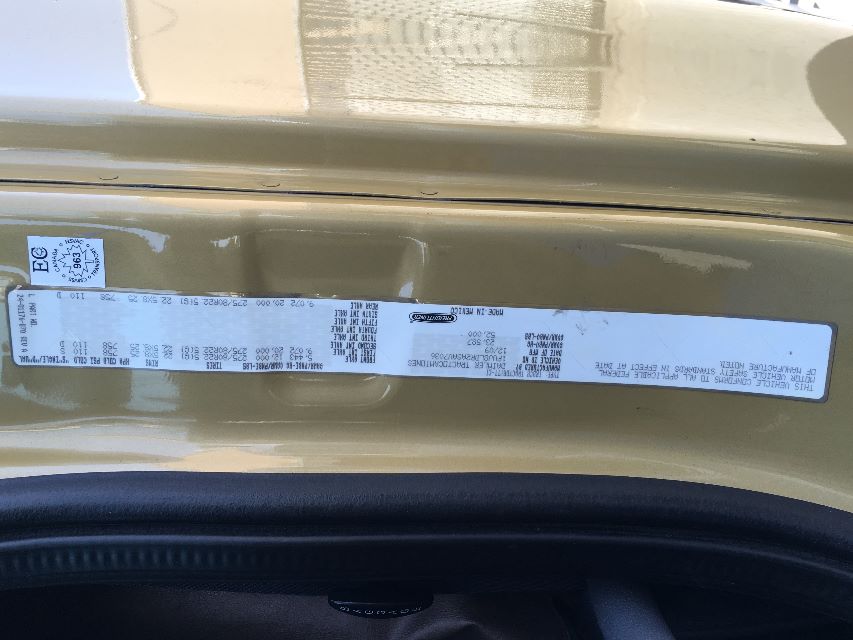 Vehicle label strip with VIN and weight/load information on the door jamb of a Freightliner Cascadia 125. Includes VIN 1FUJGLDR2ASAV7036, stock FV7036, and various serial/weight data.