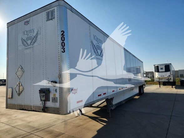 White Wabash 53' trailer with black trim, side view, rear doors, and ID number 2003. markings include hazard placards and a raised landing gear undercarriage.