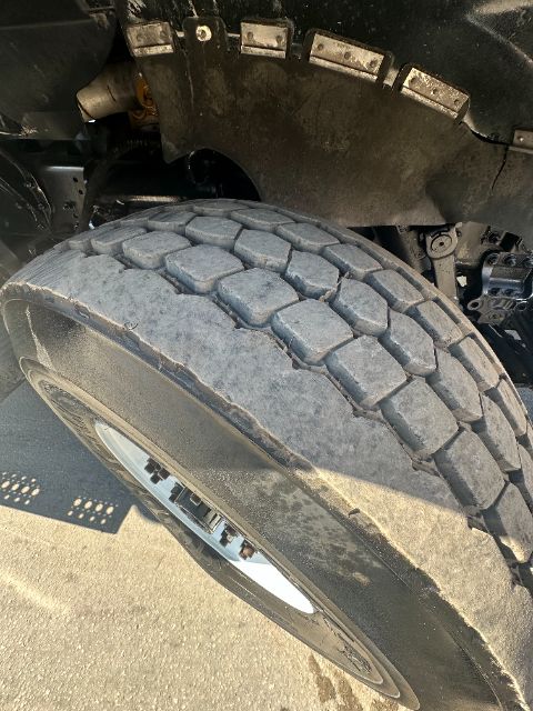 Vehicle tire and wheel of a 2006 Sterling L8500 truck showing heavy-duty tread and surrounding suspension components.