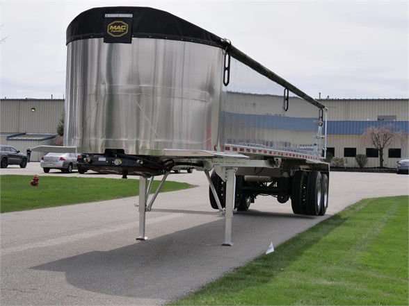 Aluminum lightweight frameless trailer with rounded front tank and dual rear wheels; stock number 068120 ALUM D; dump trailer category; new item.