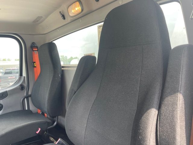 Cab interior of 2015 Freightliner M2 with front seats and seat belts visible.