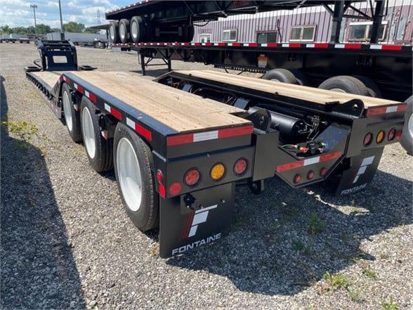 Fontaine 55 ton steel roller paver lowboy trailer with 24 ft deck, black paint, wood deck, dual rear axles and mud flaps showing Fontaine branding.