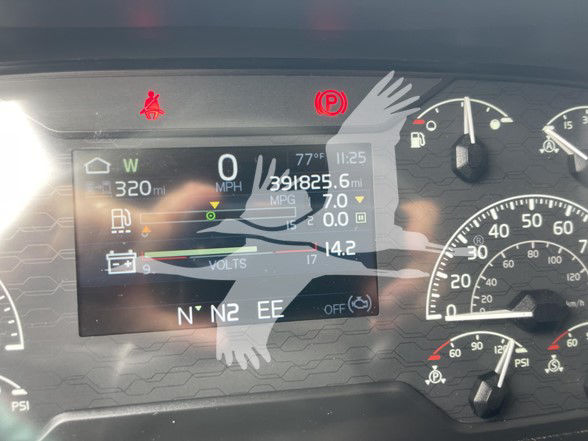 Dashboard display showing vehicle information: W 320 mi, 0 MPH, 391825 mi? MPG 7.0, volts, temperatures; N N2 EE; various icons.