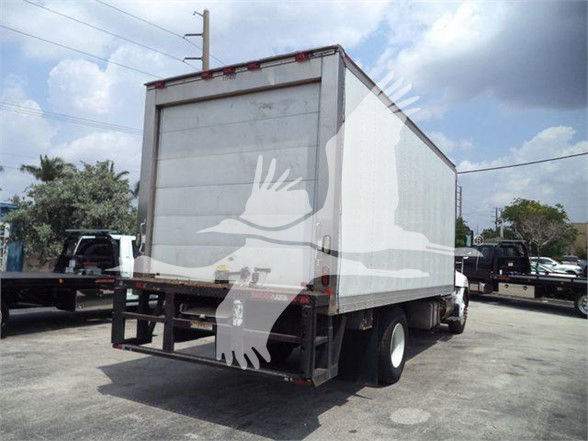 Rear view of a box truck with a white reefer cargo area, showing the back doors and bumper.
