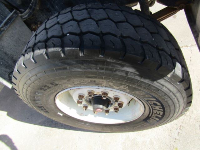 Tire and rim of a Mack CV513 wheel showing the Kumho tire tread and lug nuts.