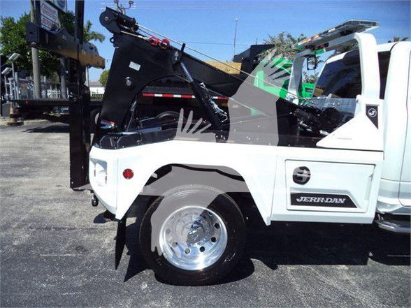 Ram 5500 tow truck side view showing wheel and Jerr-Dan brand body with crane tow equipment