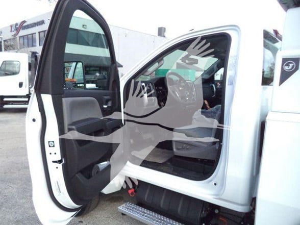 Chevrolet Silverado 6500HD truck interior with front door open, showing driver seat and dashboard area.