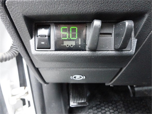 Dashboard area showing a green digital readout with '5.0' in the center, small icons below it, and toggle switches around.