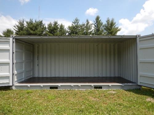 Open side shipping container interior with doors fully swung open showing metal walls and floor.