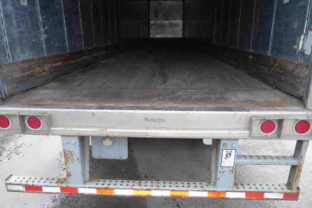 Open back of a Great Dane trailer showing empty cargo area and rear bumper with taillights and reflective tape.