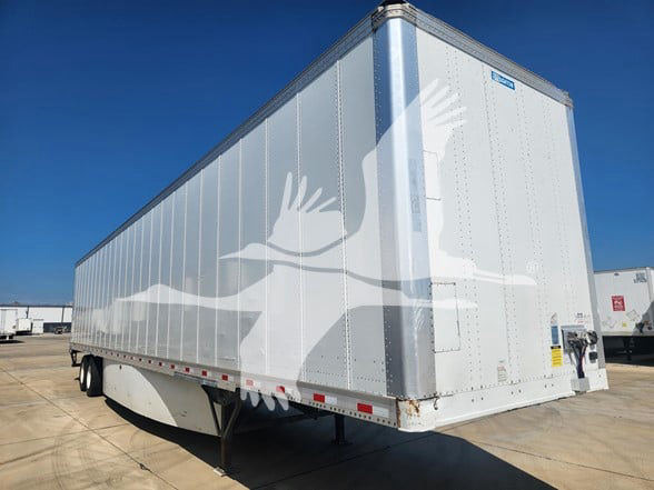 Stoughton trailer side and rear showing aluminum ribbed walls and landing gear.