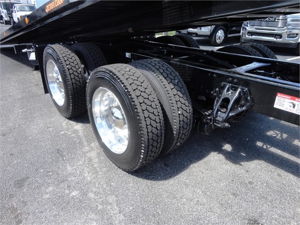 Kenworth W900 trailer with dual rear axles and tires showing undercarriage and leaf spring suspension.