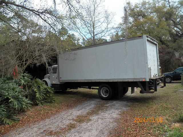 IC Corporation 4700 box truck side and rear view with long cargo box, gray exterior, single rear axle, date stamp 2024/03/03.