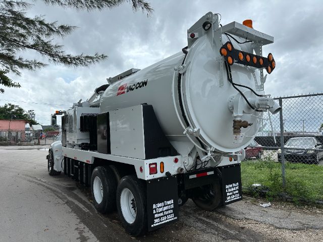 Vacuum truck rear view showing circular tank and rear light bar.