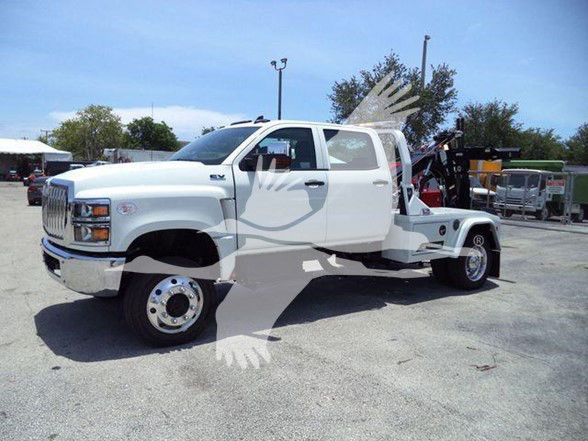 2023 International CV tow truck with white cab and flatbed recovery equipment, side profile view, VIN plate not visible
