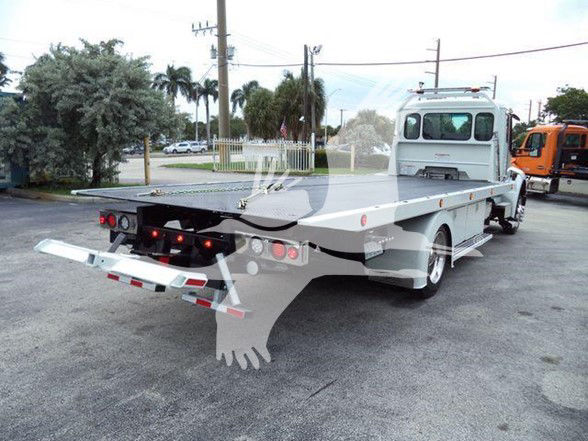 Kenworth T280 tow truck flatbed rear view showing long flatbed with hydraulic ramps and rear lights.