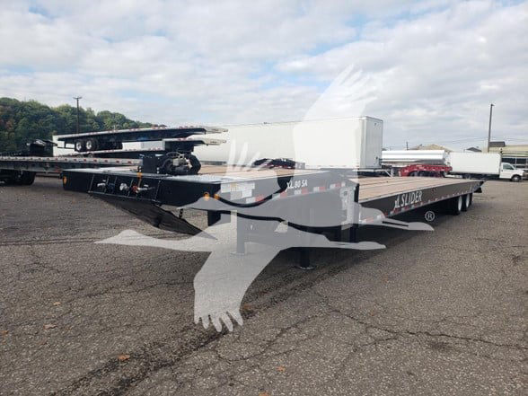 XL Specialized trailer showing flatbed with extended gooseneck and aluminum toolbox, SL024323 visible.