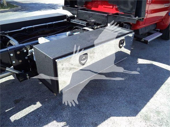 Truck bed toolbox mounted in the Chevy Silverado 6500HD chassis with visible latch handles and mounting area.