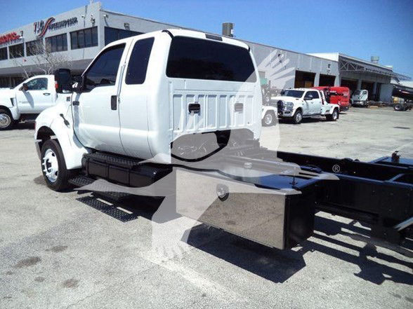 2015 Ford F650 XLT tow truck with flatbed and cab in view, showing rear side details but no legible labels.