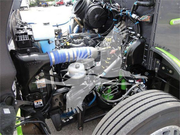 Peterbilt 337 engine bay showing blue intake hose, various hoses, and components in the front left side.