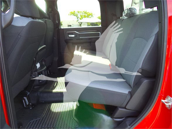 Ram 5500 pickup interior showing front and rear seats with gray fabric upholstery and red exterior door frame.