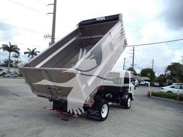 Dump truck with raised cargo bed showing Chevrolet W4500 branding and dump mechanism.