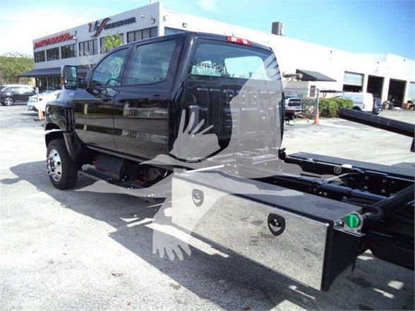 2023 International CV truck chassis with cab visible, side view shows wheel, cab, and attached utility box; dealership lot in background.
