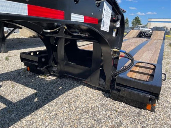 Fontaine 55 ton steel roller paver lowboy trailer showing wooden deck and hydraulic components at the rear.