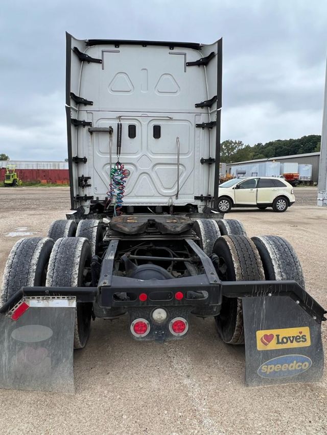 Freightliner Cascadia rear view showing tractor driver area, fifth wheel and dual rear axle with mud flaps and basic lighting.
