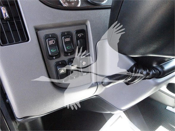 Peterbilt truck interior controls panel showing headlight and indicator switches and steering column area.