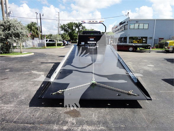 Tow truck flatbed with a hydraulic ramp, front view; no legible branding or text visible on the equipment.