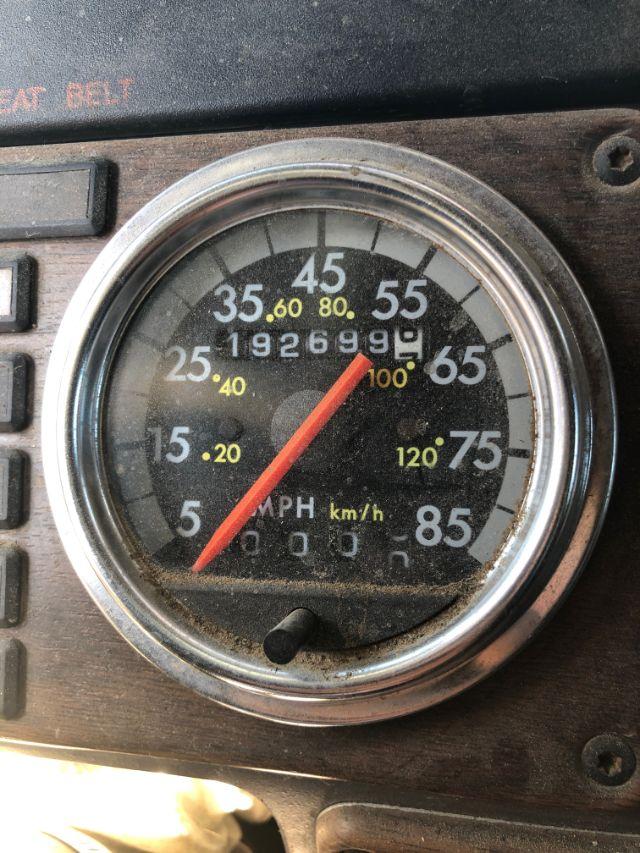 Dashboard gauge showing speedometer with 0-85 mph scale and odometer reading, in-service truck