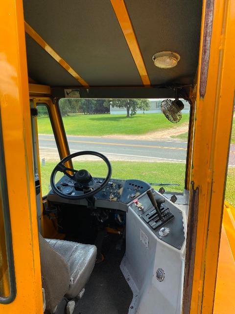 Operator cab of a 2011 Ottawa yard spotter 4x2 showing steering wheel and control panel.