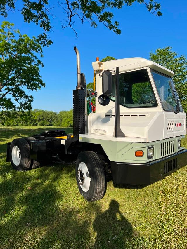 Kalmar Ottawa T2 4x2 yard truck front-left view with cab, exhaust stack, and dual rear wheels.