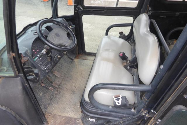 Club Car Carryall 1700 interior showing steering wheel, dashboard, and front bench seat in vehicle cabin.