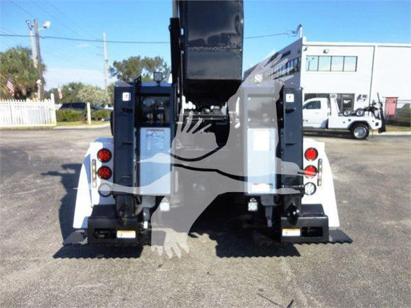 Rear view of Freightliner BUSINESS CLASS M2 106 tow truck chassis with hydraulic arms and taillights.