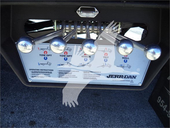 Isuzu FTR tow control panel with chrome handles labeled TOW OPT, WINCH, TILT, ROLL. JERR-DAN label visible. Operating instructions text at bottom.