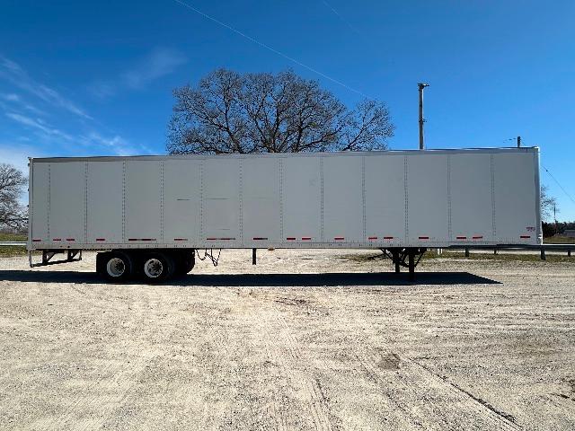 Trailer side view of a 2015 Wabash DuraPlate dry van with three axles, gray exterior, and landing gear visible.