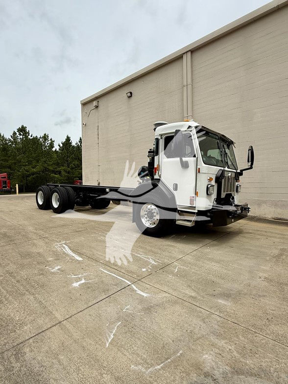 Kenworth L770 cab chassis truck showing front and side view with white cab and black undercarriage, trailerless chassis.